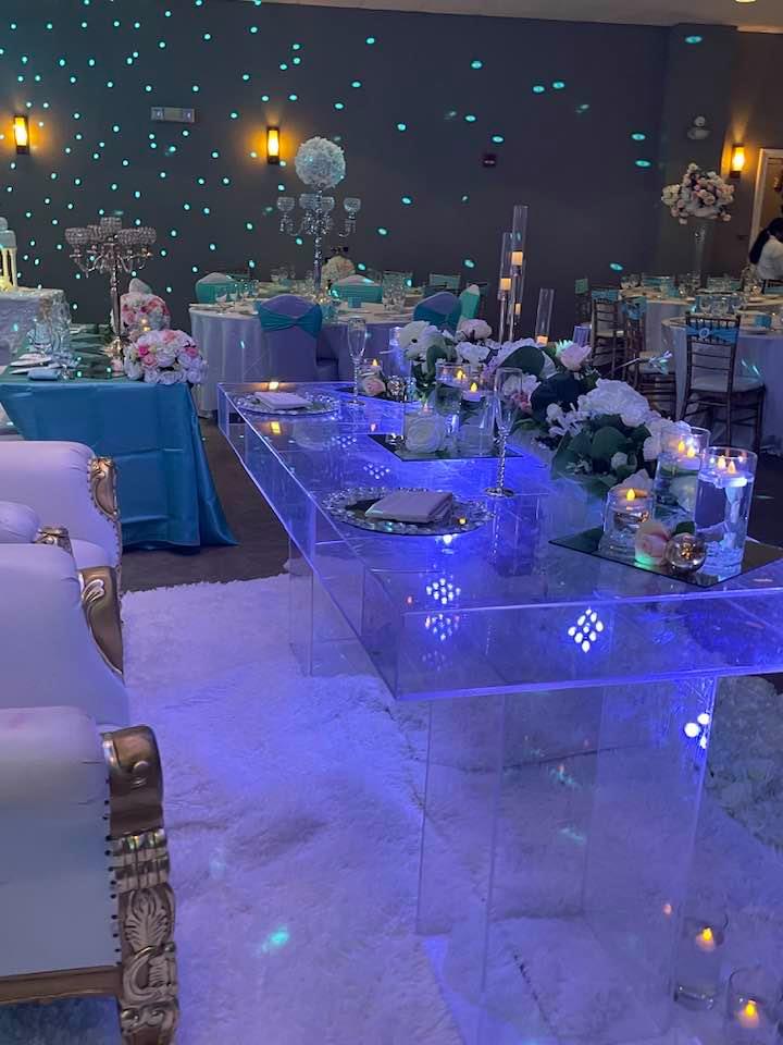 Modern wedding reception with starry wall, acrylic dining table, ghost chairs, and candles